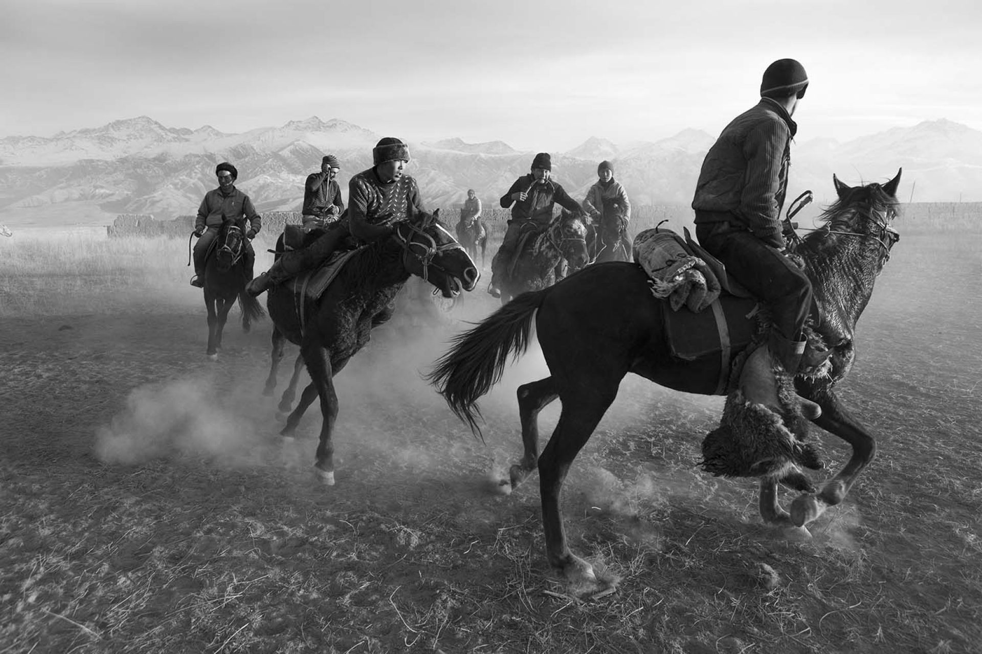 Kyrgyzstan has always been a nation of horsemen and has rich nomadic heritage and traditions that have been woven into the identity of the Kyrgyz people. During summer months, many families continue to graze their herds in mountain meadows, called jailoos, preserving old customs and ways of nomadic life. In winter the shepherds and their livestock have to deal with incredible harsh weather conditions in the mostly mountainous terrain. Most winter evenings these days are spent in front of a television and the warmth of an always-burning stove. And although even the isolated areas often have cellphone reception nowadays, most of their daily life hasn’t changed much in the last decades.
The horse has always had a central role in their semi-nomadic life. It is crucial to herd their animals in the mountains and the horse is also indispensable for its milk and meat.
Also the Kyrgyz like to spend their leisure time on the back of a horse and they often play games in which horsemanship dominates all competitions, like Kok Boru in which teams on horse fight over a carcass of a sheep.