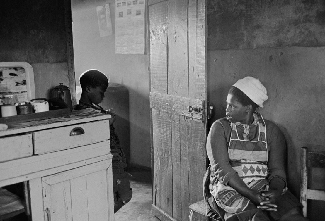 SOUTH AFRICA. 1960s. Township mother fights losing battle to keep son, age nine, from running off to live life of the streets. She tries to assert authority with threats: “What’s your future going to be like without an education?