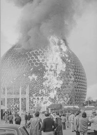 (Original Caption) U.S. Pavilion Burns. Montreal: The former U.S. Pavilion at the Expo 67, designed by architect Buckminister Fuller, which cost $3,000,000 to build, burst into flames, May 20. The fire, which lasted about 20 minutes, sent clouds of thick smoke into the air from the plexiglass sphere. There were no injuries at the sphere, which has been used as an environmental pavilion at "Man and His World."